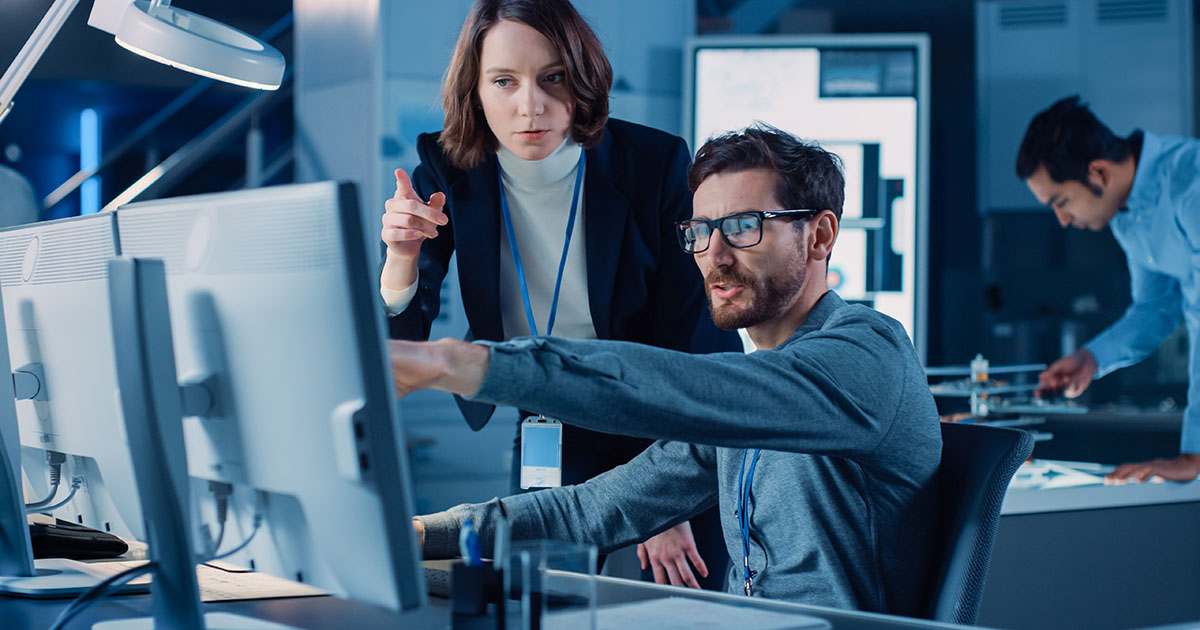 A professional cybersecurity expert monitoring real-time data on multiple digital screens, representing 24/7 cloud protection and network security services.